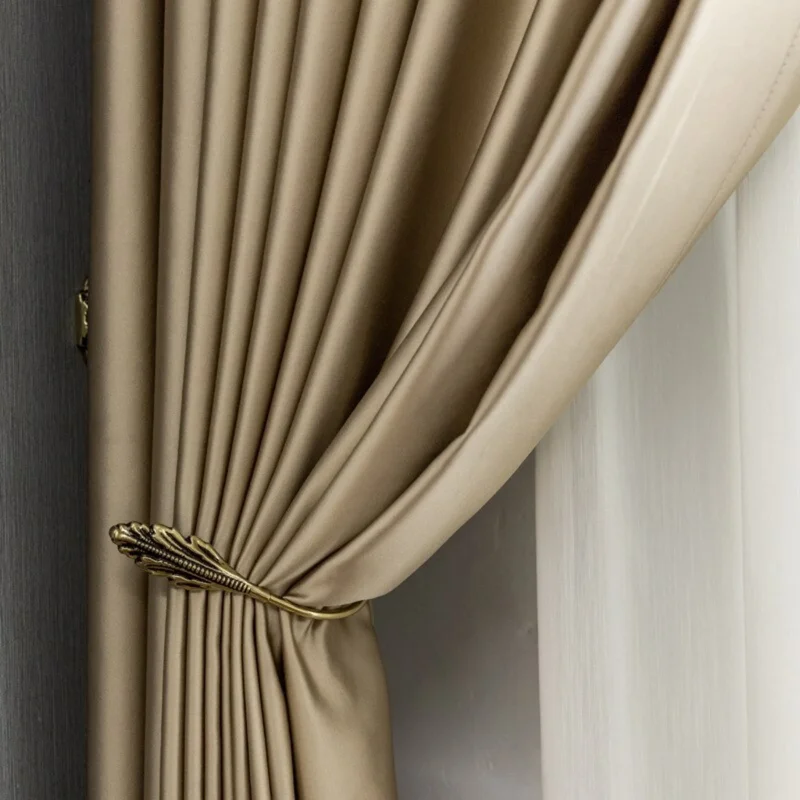 Luxurious silk curtains with a metallic tieback.
