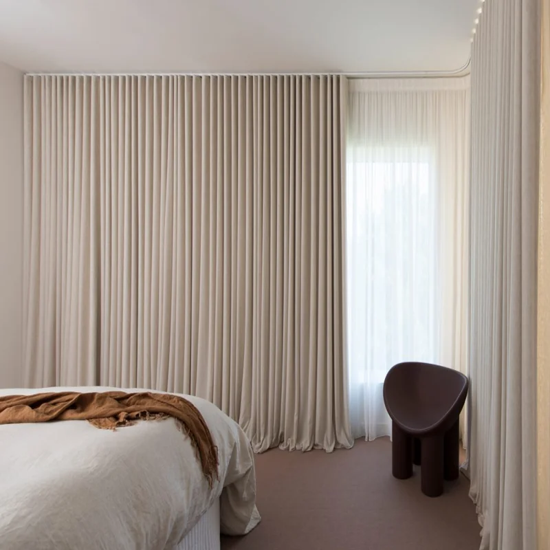 Completed blackout curtain installation in modern bedroom